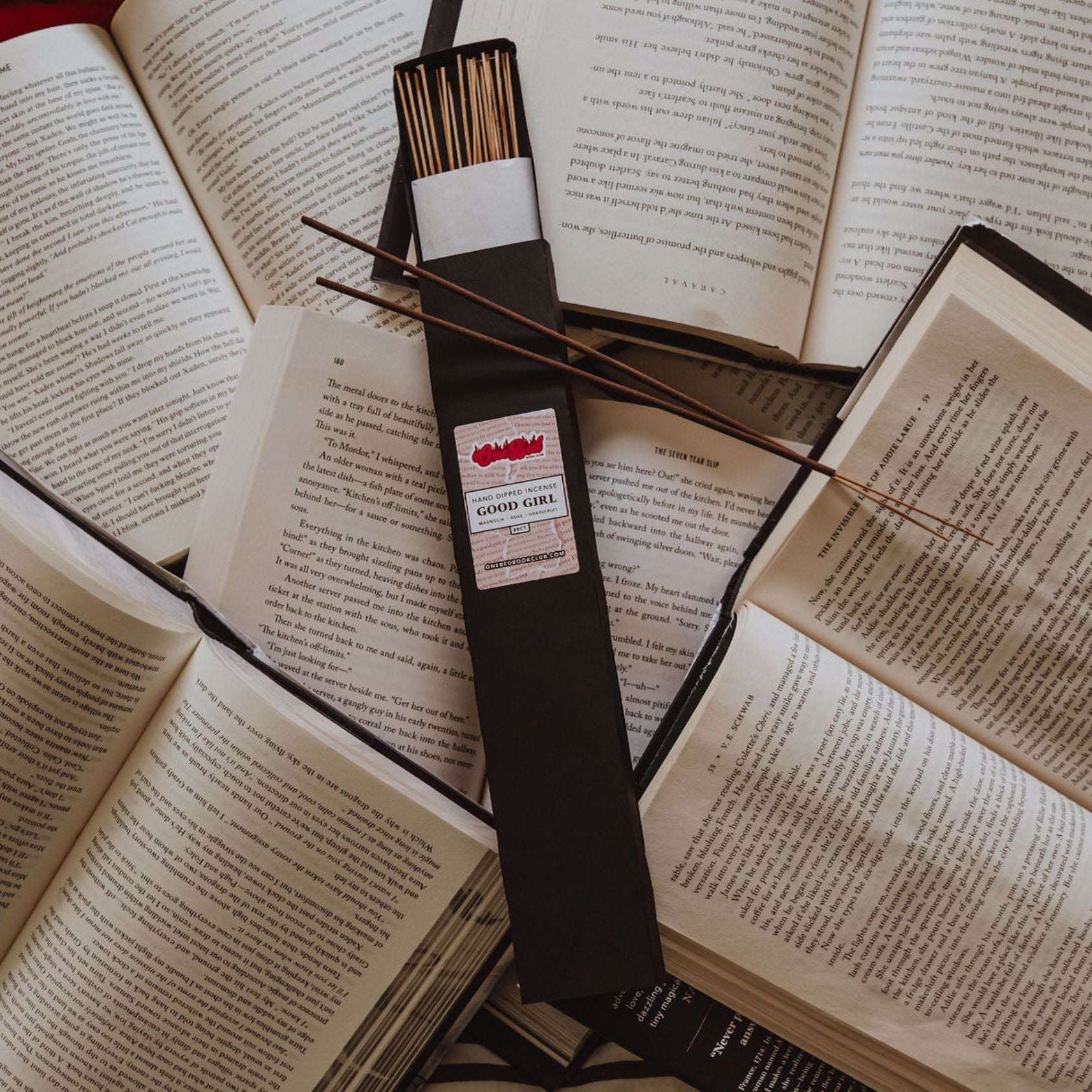 Bundle of incense sticks on a book with red text reading “Is That Smut?” visible nearby.
