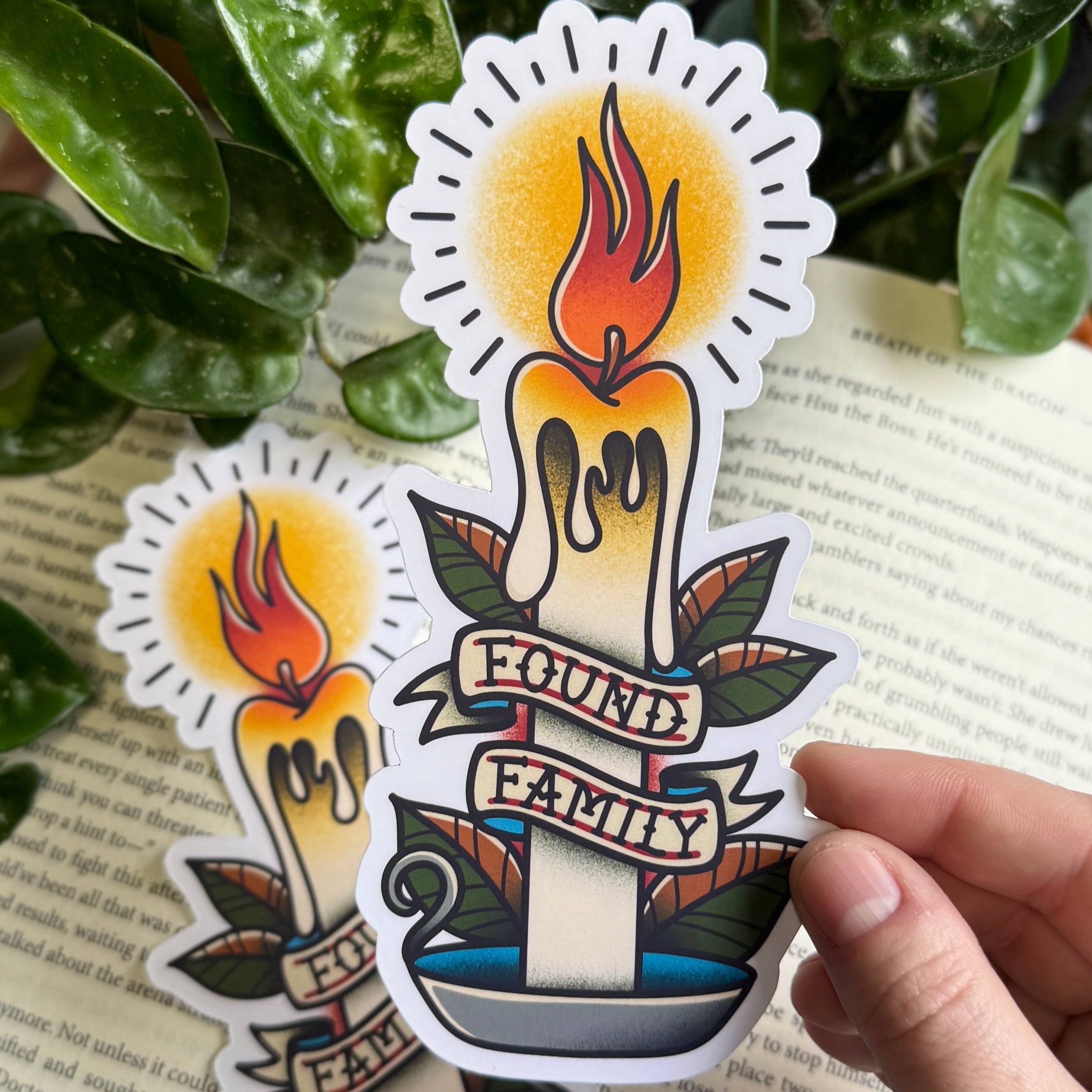 Bookmark featuring a burning candle with a banner that says Found Family