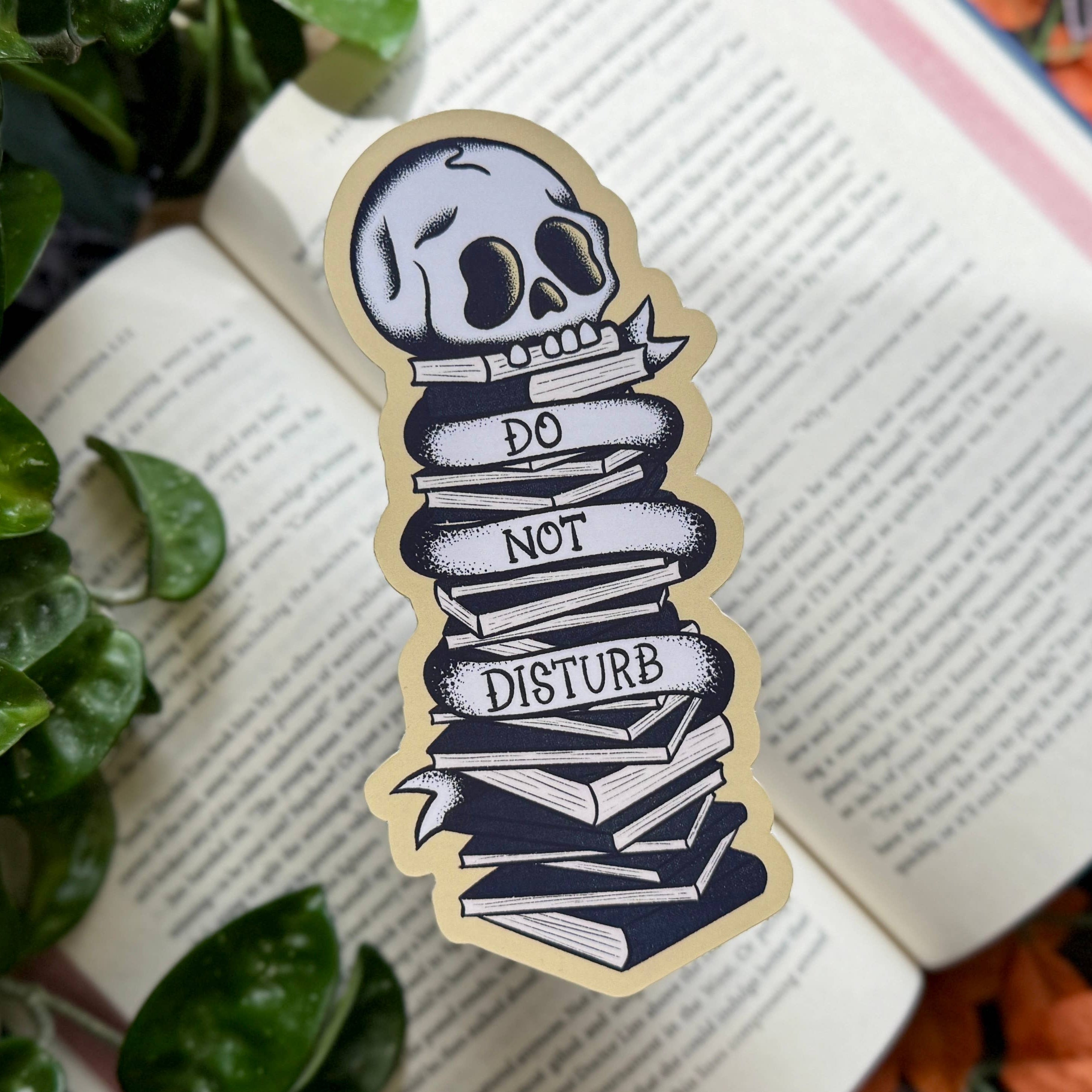Skull bookmark with “Do Not Disturb” text on a stack of books